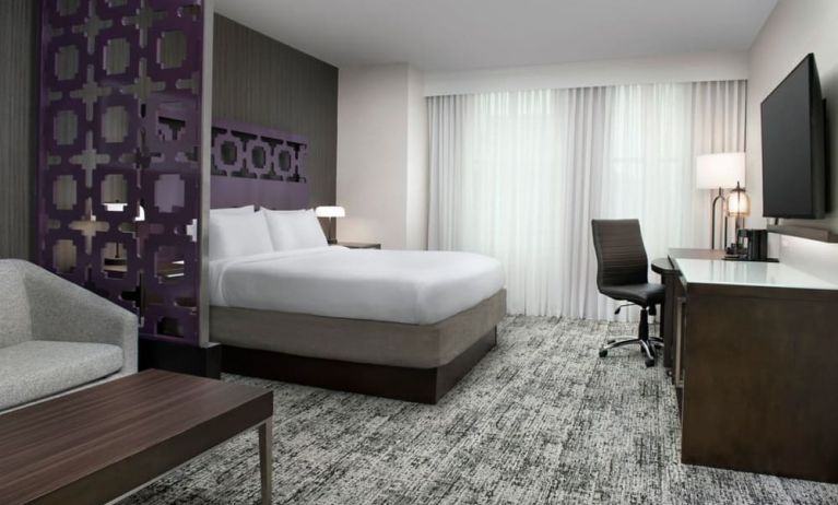 King bedroom with TV and business desk at Courtyard San Diego Downtown.