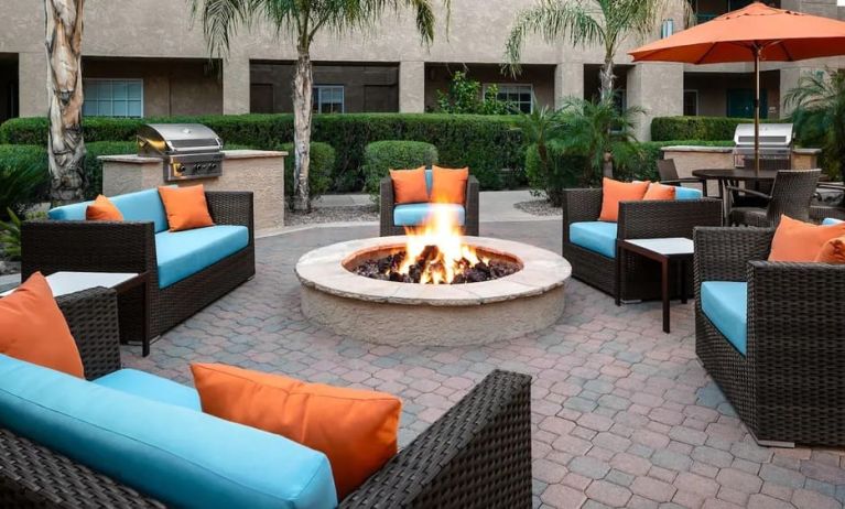 Outdoor lounge and coworking space with fire pit at Hyatt House Scottsdale.