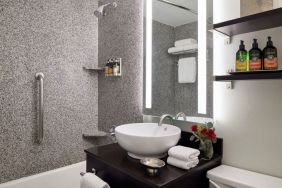 Private guest bathroom with shower and bath at Capitol Hill Hotel.