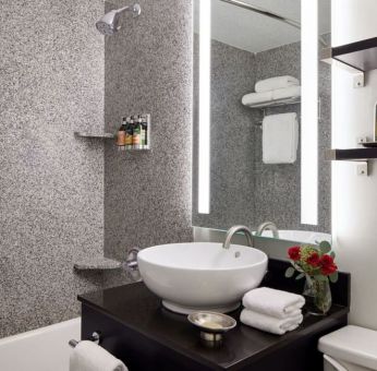 Private guest bathroom with shower and bath at Capitol Hill Hotel.