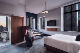 King bedroom with TV and business desk at Hotel Caza.