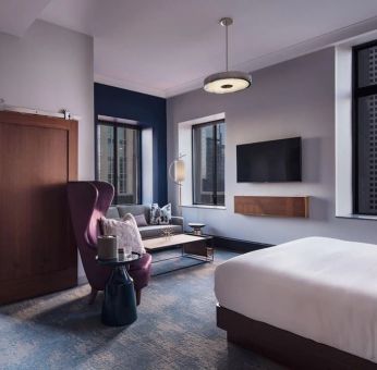 King bedroom with TV and business desk at Hotel Caza.