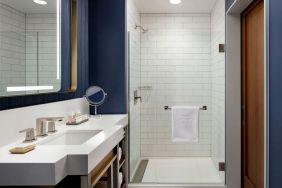 Private guest bathroom with shower and bath at Hotel Caza.