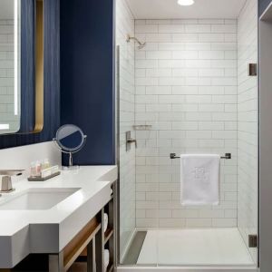 Private guest bathroom with shower and bath at Hotel Caza.