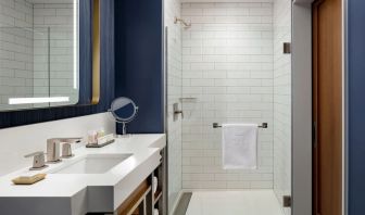 Private guest bathroom with shower and bath at Hotel Caza.