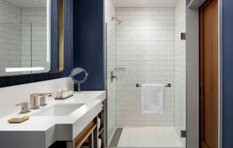 Private guest bathroom with shower and bath at Hotel Caza.