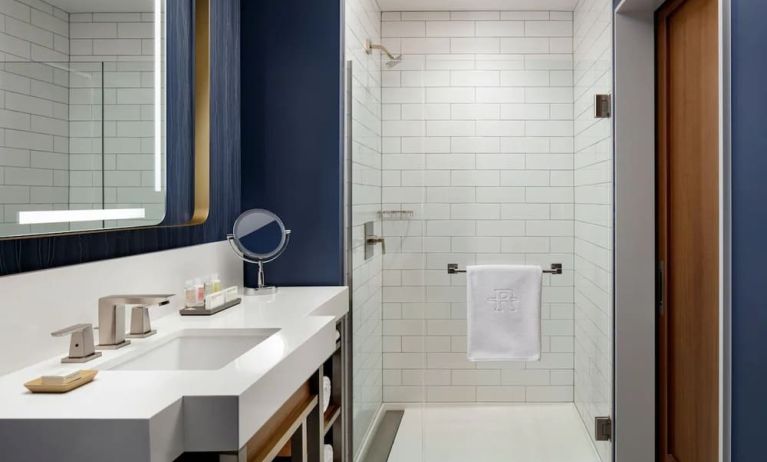 Private guest bathroom with shower and bath at Hotel Caza.