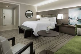 Comfortable king bedroom with lounge area at The Westin New Orleans.