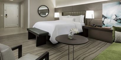 Comfortable king bedroom with lounge area at The Westin New Orleans.