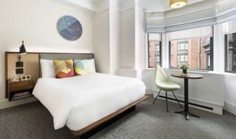 Delux king room with desk and chair at The James New York, NoMad.