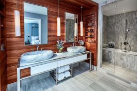 Private guest bathroom with shower and bath at The James New York, NoMad.