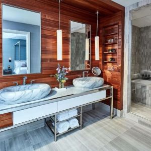 Private guest bathroom with shower and bath at The James New York, NoMad.