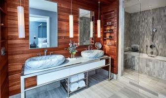 Private guest bathroom with shower and bath at The James New York, NoMad.