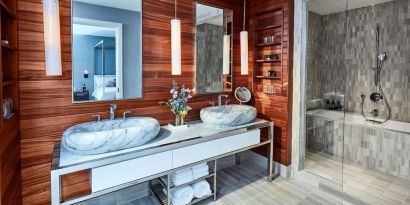 Private guest bathroom with shower and bath at The James New York, NoMad.