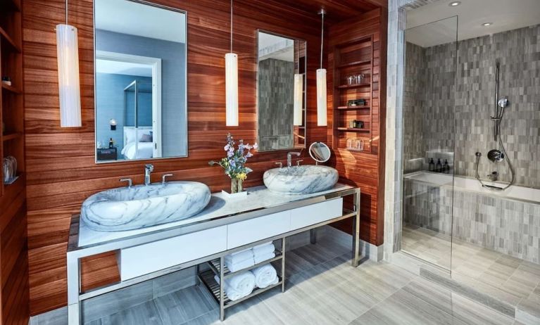 Private guest bathroom with shower and bath at The James New York, NoMad.