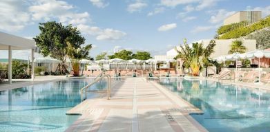 Stunning outdoor pool with pool seating area at The Goodtime Hotel.