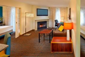 Spacious king room with TV and lounge at Residence Inn Boston Tewksbury.
