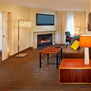 Spacious king room with TV and lounge at Residence Inn Boston Tewksbury.
