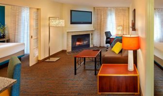 Spacious king room with TV and lounge at Residence Inn Boston Tewksbury.
