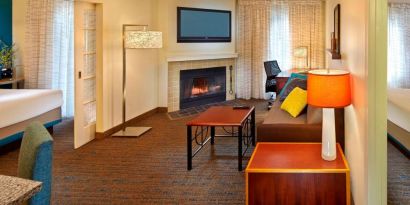 Spacious king room with TV and lounge at Residence Inn Boston Tewksbury.
