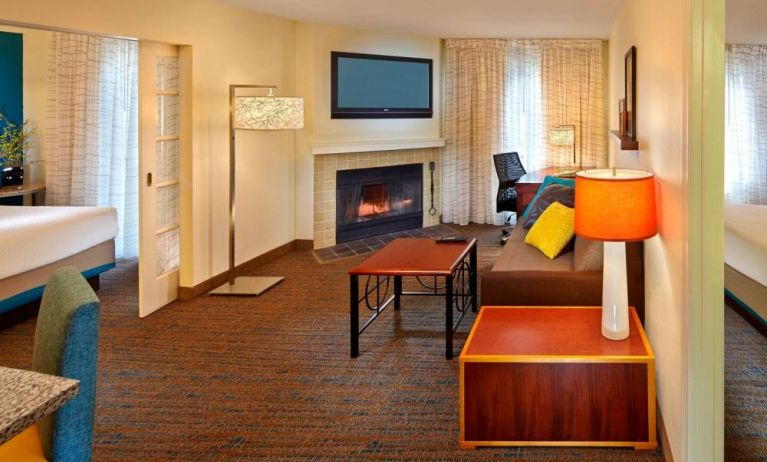 Spacious king room with TV and lounge at Residence Inn Boston Tewksbury.
