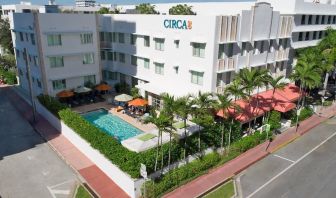 Pool area surrounded by pool chairs and greenery at Circa 39 Hotel.