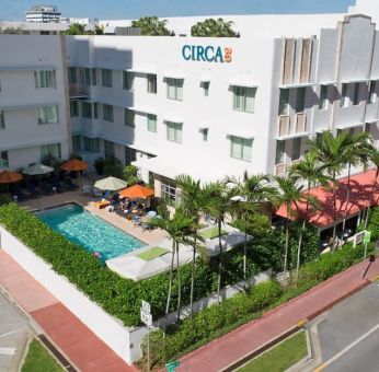 Pool area surrounded by pool chairs and greenery at Circa 39 Hotel.