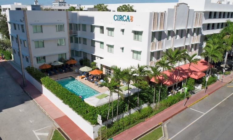 Pool area surrounded by pool chairs and greenery at Circa 39 Hotel.