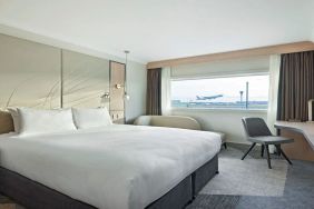 King bedroom with work desk and natural light at Hyatt Place London Heathrow Airport.