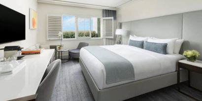 King room with desk and TV at The Mosaic Hotel Beverly Hills.