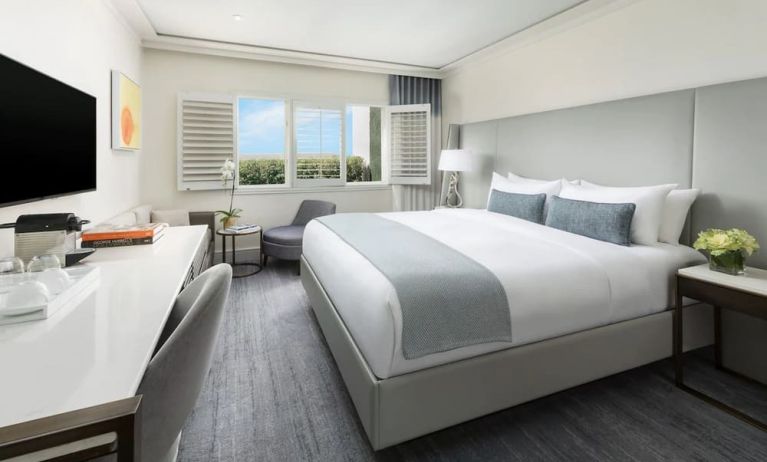 King room with desk and TV at The Mosaic Hotel Beverly Hills.