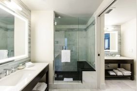 Private guest bathroom with shower at The Mosaic Hotel Beverly Hills.