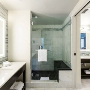 Private guest bathroom with shower at The Mosaic Hotel Beverly Hills.