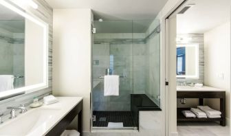 Private guest bathroom with shower at The Mosaic Hotel Beverly Hills.