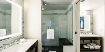 Private guest bathroom with shower at The Mosaic Hotel Beverly Hills.