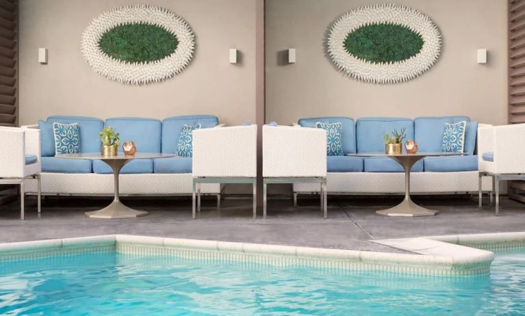 Relaxing pool area with comfortable seating at The Mosaic Hotel Beverly Hills.