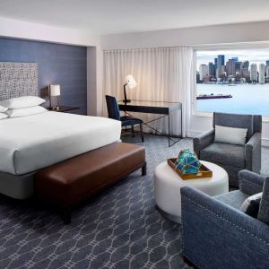 King bed with TV and desk at Hyatt Regency Boston Harbor - Logan Airport.