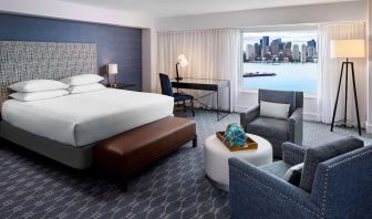 King bed with TV and desk at Hyatt Regency Boston Harbor - Logan Airport.