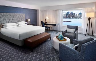 King bed with TV and desk at Hyatt Regency Boston Harbor - Logan Airport.