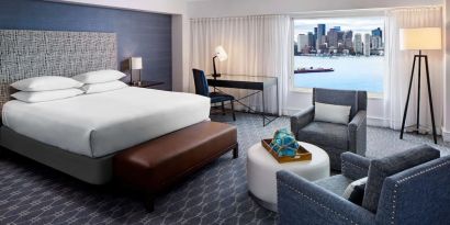 King bed with TV and desk at Hyatt Regency Boston Harbor - Logan Airport.