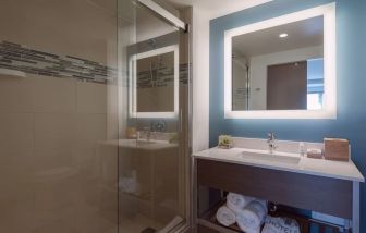 Private guest bathroom with shower at Even Hotel Brooklyn.