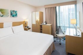 King bed with natural light and work desk at Hilton Garden Inn Bristol City Centre.