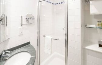 Private guest bathroom with shower at Hilton Garden Inn Bristol City Centre.