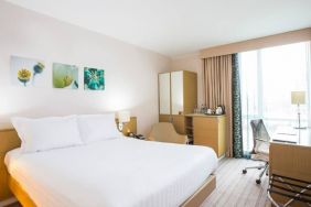 King bed with natural light and work station at Hilton Garden Inn Glasgow City Centre.