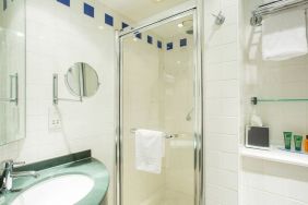 Private guest bathroom with shower at Hilton Garden Inn Glasgow City Centre.