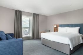 Delux king bed with natural light at Hilton Garden Inn London Heathrow Terminals 2 And 3.