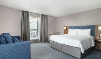 Delux king bed with natural light at Hilton Garden Inn London Heathrow Terminals 2 And 3.