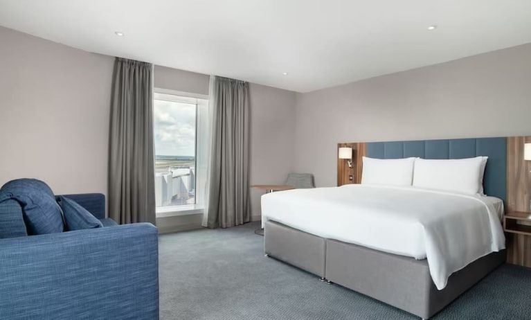 Delux king bed with natural light at Hilton Garden Inn London Heathrow Terminals 2 And 3.