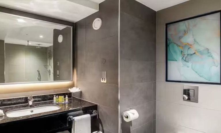 Private guest bathroom with shower at Hilton Garden Inn London Heathrow Terminals 2 And 3.