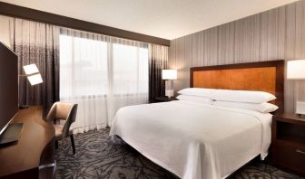 Delux king room with TV and work desk at Embassy Suites By Hilton Santa Clara Silicon Valley.